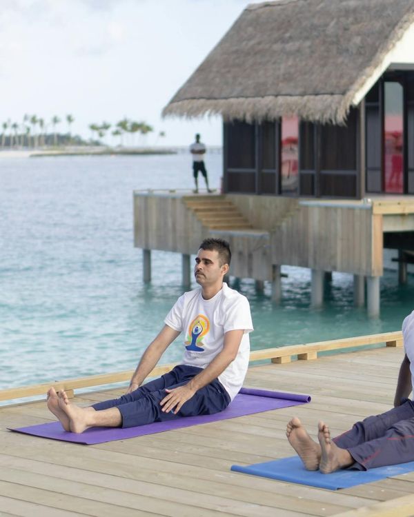 Man stretching outdoors feeling calm and focused at sunrise.